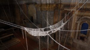 Monica Bonvicini, “And Rose”, detail, installation view at San Carlo Cremona, Cremona, Italy, 2024, galvanized steel rings, chain links and chains, 9 x 11 meters. Courtesy the artist. Photo credit: Form Group © Monica Bonvicini and VG Bild-Kunst/SIAE